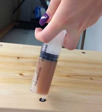 Injection of Timber Paste  into a timber via an injector.