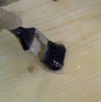 Brushing Boron Gel onto bare wood - for woodworm treatment inside furniture.